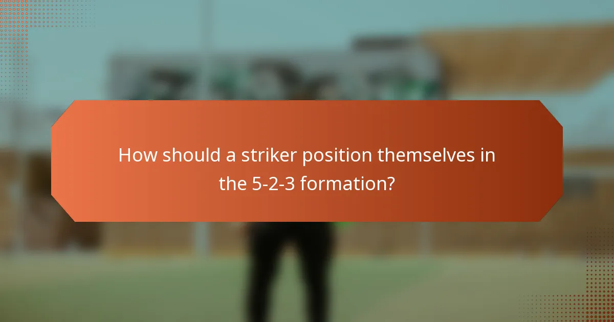 How should a striker position themselves in the 5-2-3 formation?
